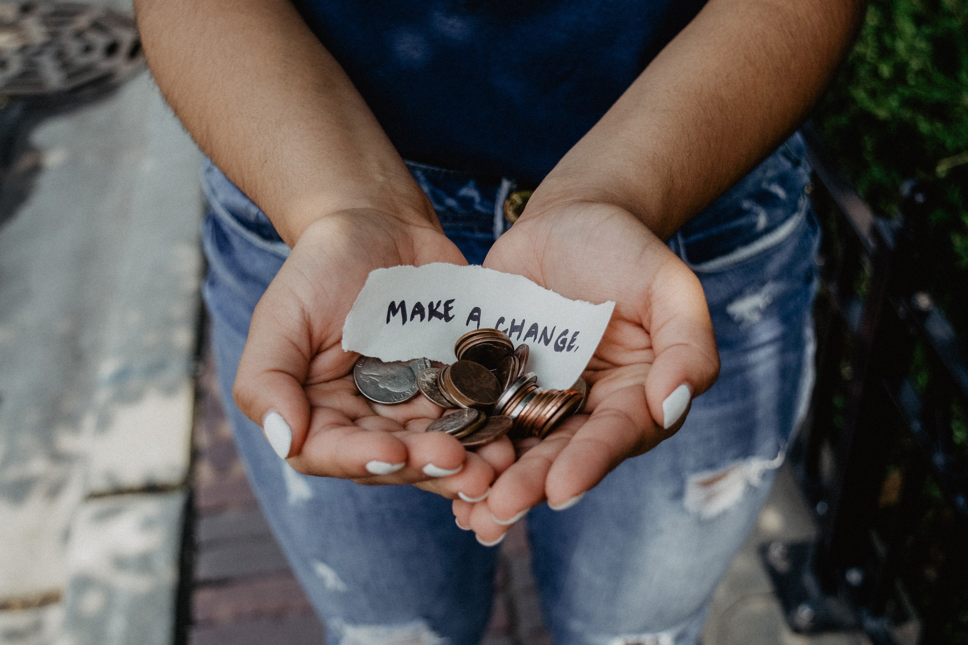 image of a person holding a "Make Change" sign