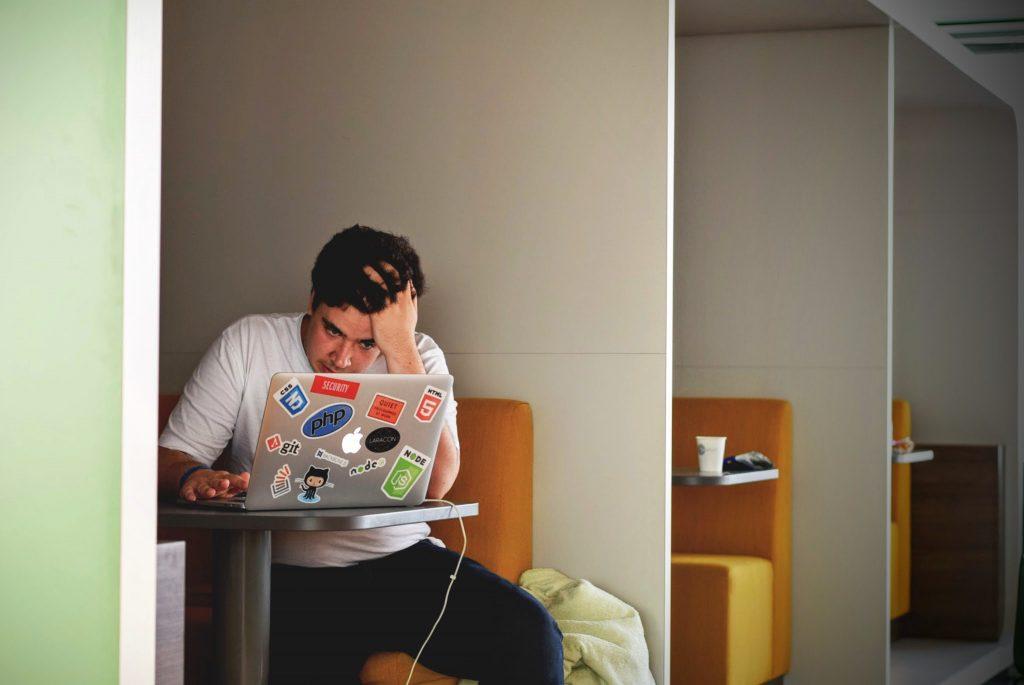 image of frustrated man using a laptop