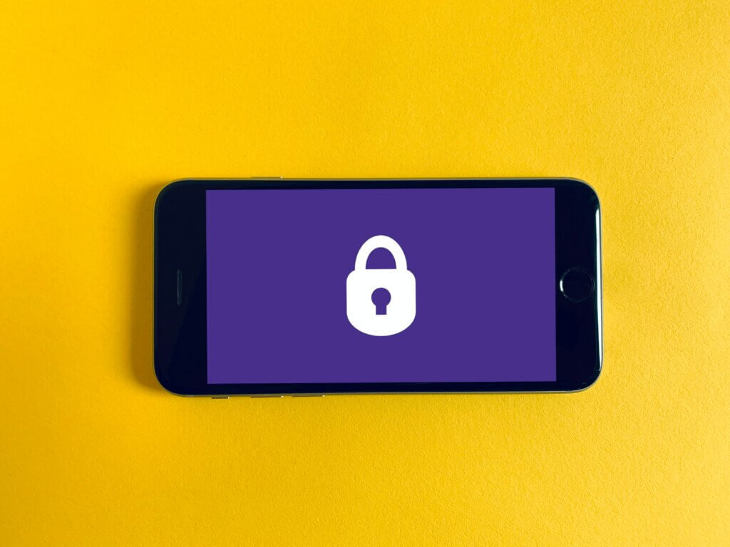 Smart phone showing lock icon on yellow background.